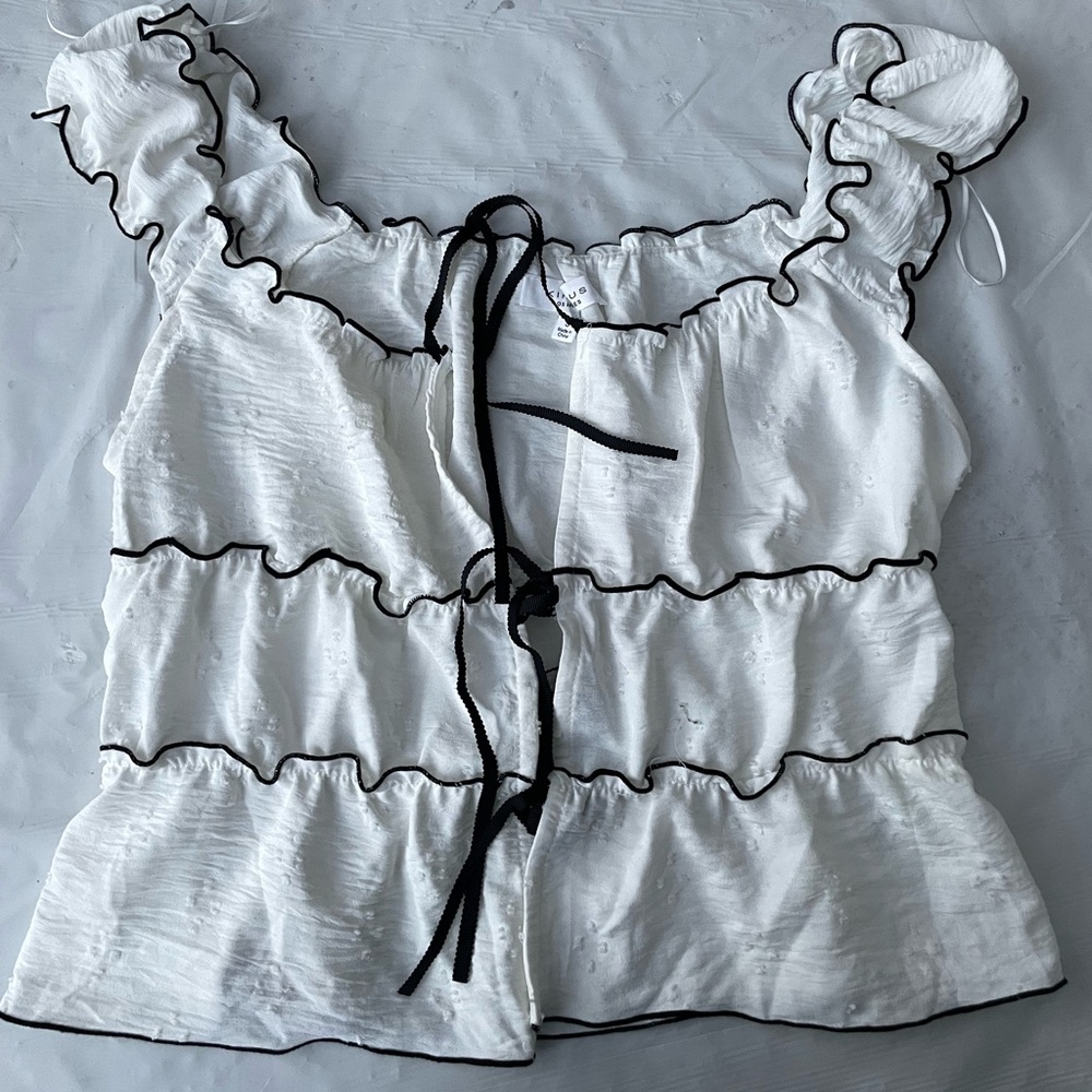 Chic White Ruffled Blouse with Black Trim